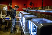 A student printing masks at DXARTS' McMahon FabLab (Dennis Wise/UW)