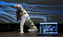 Real-time human-machine interaction during rehearsal. A dance artist performs in front of a projection controlled by our system described in the paper. The laptop screen shows the multimedia interface, while wearable IMU sensors and a smartphone are used to stream and monitor real-time data. Real-time human-machine interaction during rehearsal. A dance artist performs in front of a projection controlled by our system described in the paper. The laptop screen shows the multimedia interface, while wearable IMU sensors and a smartphone are used to stream and monitor real-time data.