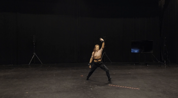 Image of performer Emily Schoen Branch wearing five motion tracker sensors, tracking wrist, hand, torso and ankles during the Research Lab