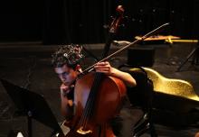 Cellist Jay Campbell of JACK Quartet checks sheet music during a rehearsal break at the “brain-art initiative” at Meany Studio Theater. (Alan Berner/The Seattle Times)